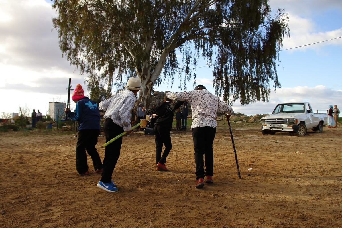 Young riel dancers of Die Nuwe Graskoue Trappers dancing on a dust yard in the Cederberg